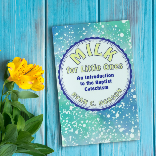 Milk for little ones book next to flower. Baptist Catechism for children.